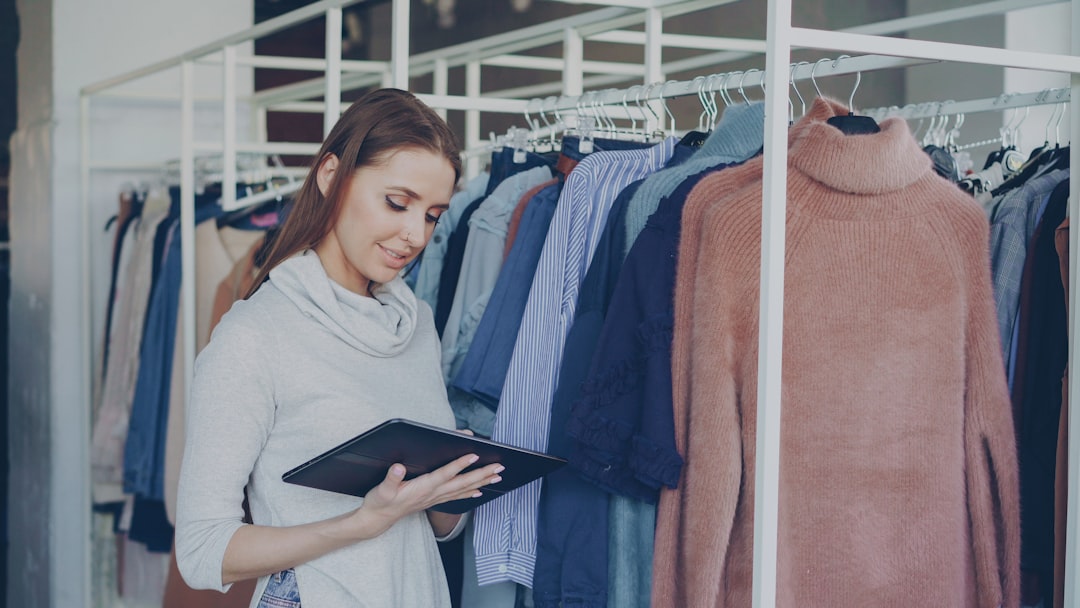 Woman uses a tablet in a clothing store