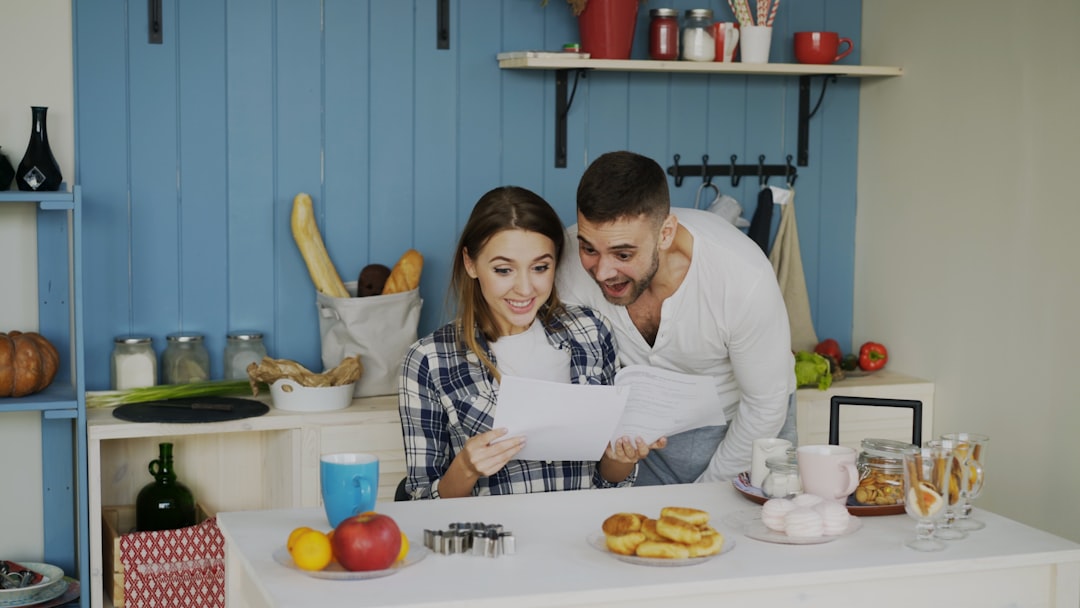 Couple looking at papers in a bright kitchen