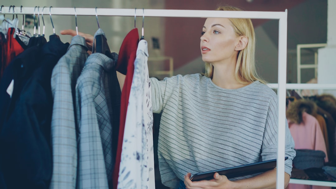 A woman chooses clothes from a rack